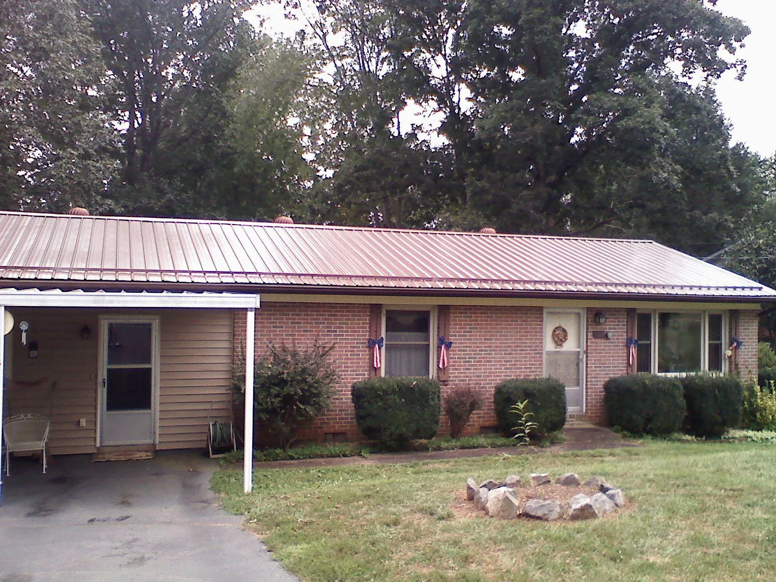 Bronze metal roof and carport on a brick ranch home — Roof Repair work by our crew in Cohasset